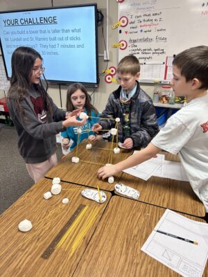 Four-students-build-a-spaghetti-marshmallow-tower